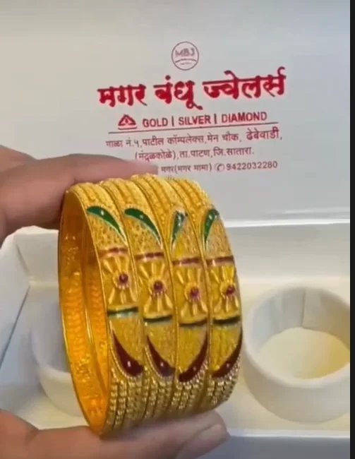 Set of four gold bangles with green and red enamel work